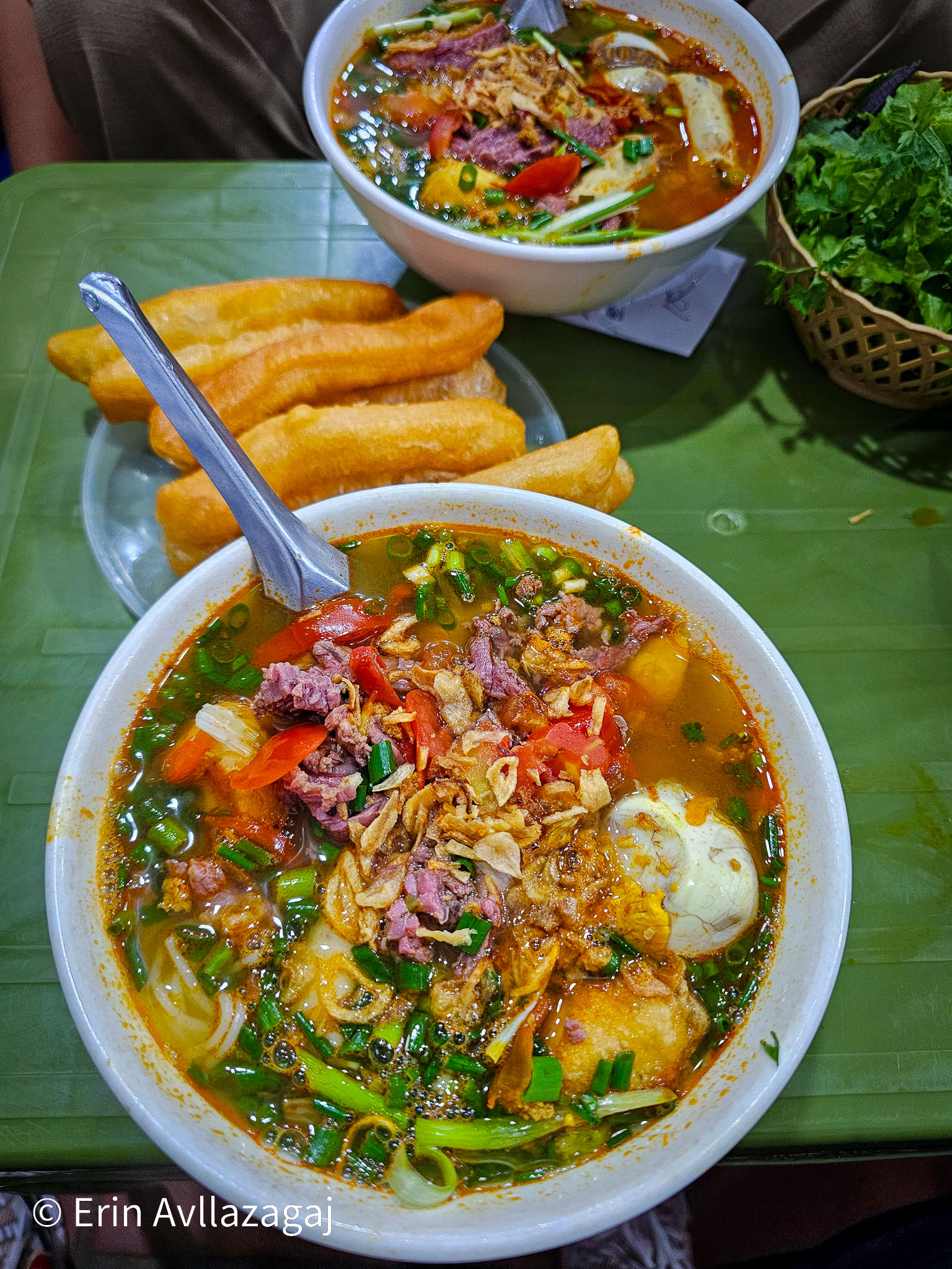 Bún Riêu (Crab Noodle Soup) with bread sticks.